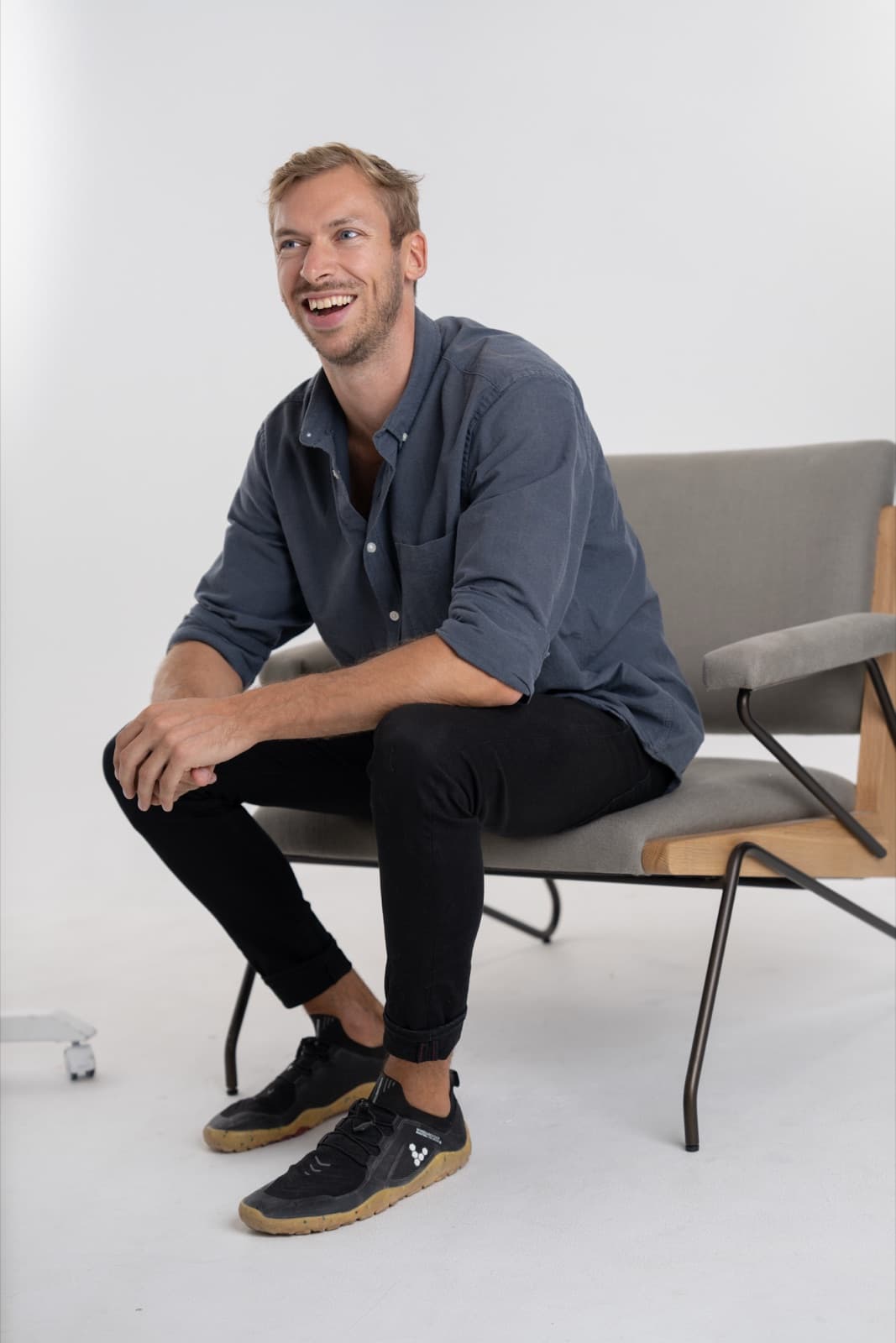 Richard, founder of GapShark, laughing in an armchair